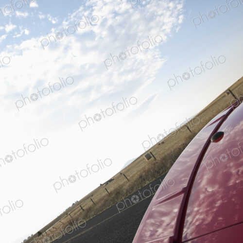 Trunk of Red Car Reflecting Clouds Trunk of Red Car Reflecting Clouds