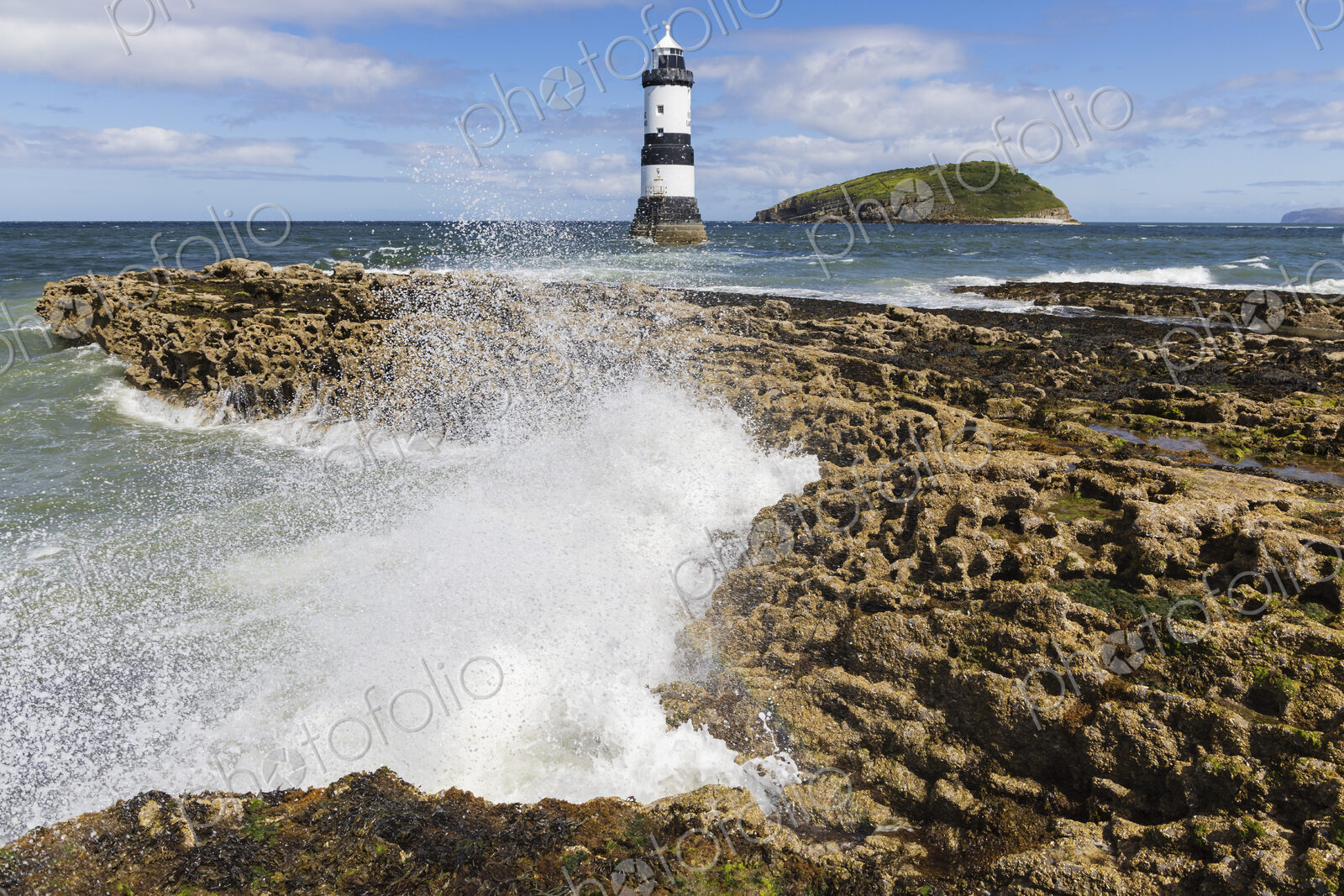 Trwyn Du Lighthouse, a lighthouse built at Penmon in the 1830s, black and white tower.