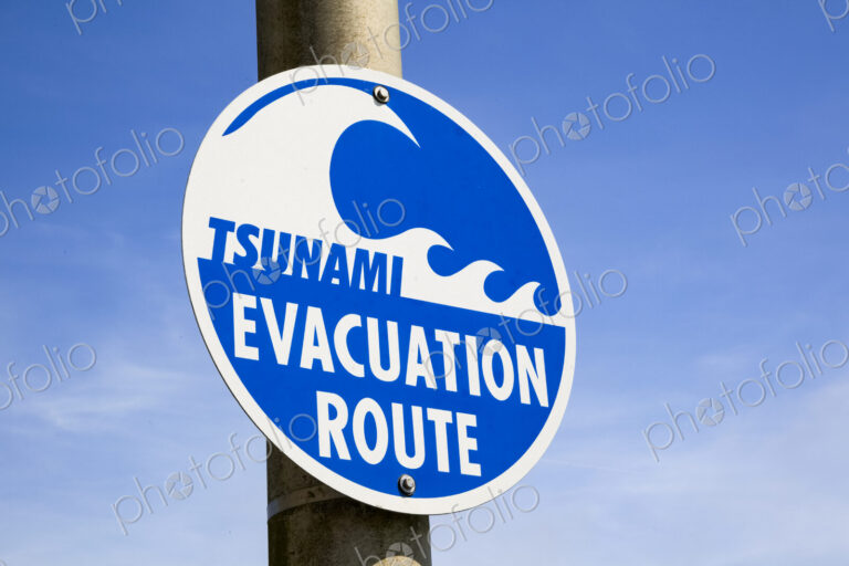 Tsunami Evacuation Route road sign, a graphic sign with lettering on a pole.