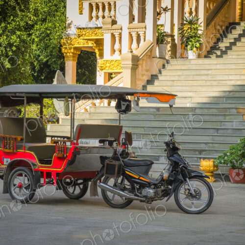Tuk tuk taxi on street outside grand staircase to hotel or resort. Tuk tuk taxi on street outside grand staircase to hotel or resort.