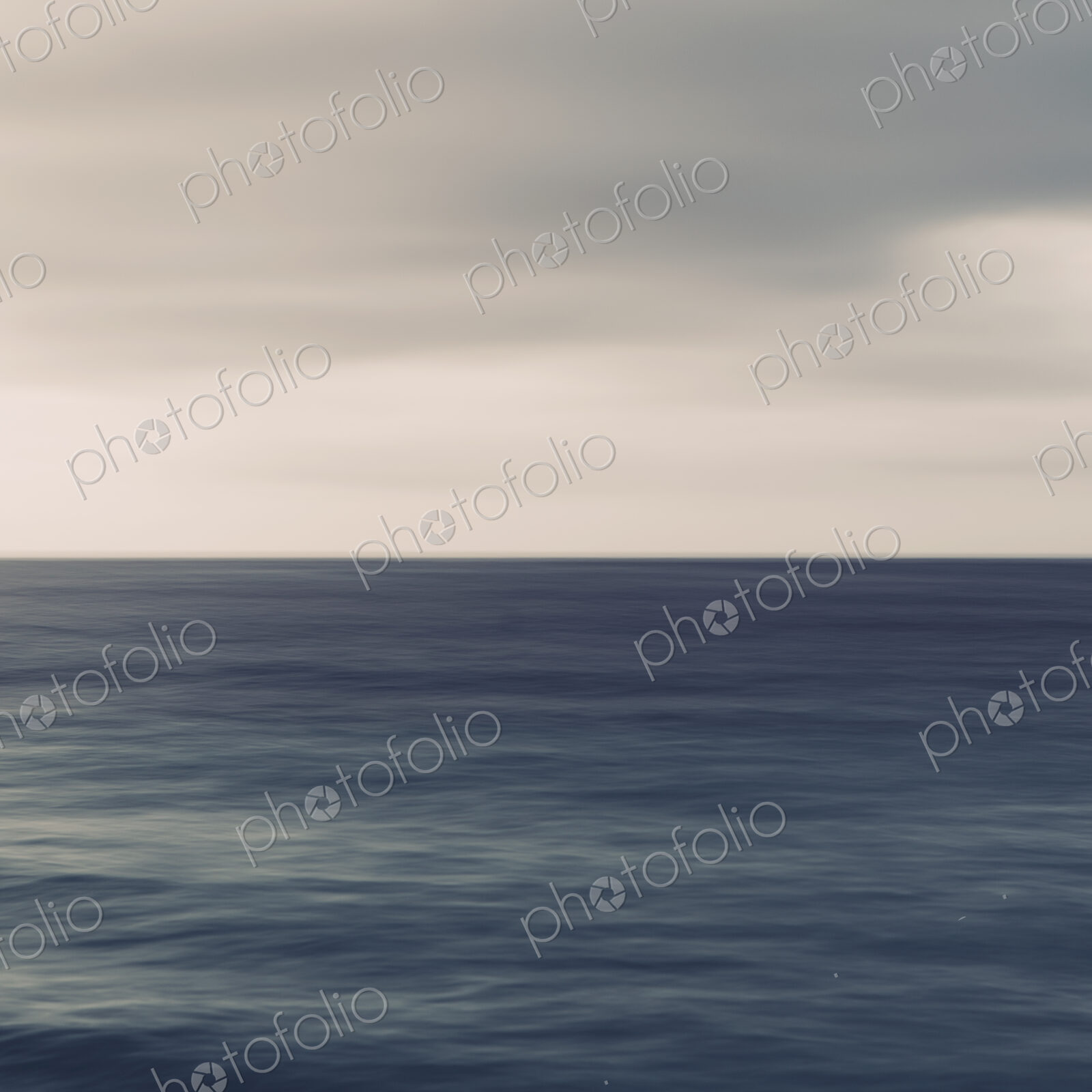 Turquoise ocean, ripples on the surface and overcast sky.