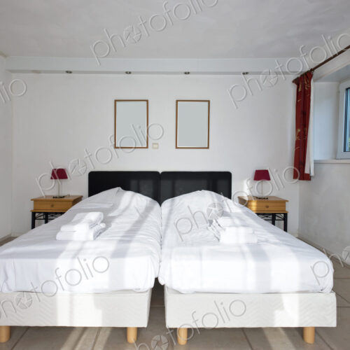 Twin beds pushed together in bedroom