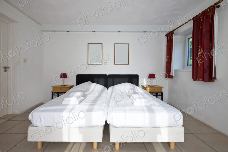 Twin beds pushed together in bedroom