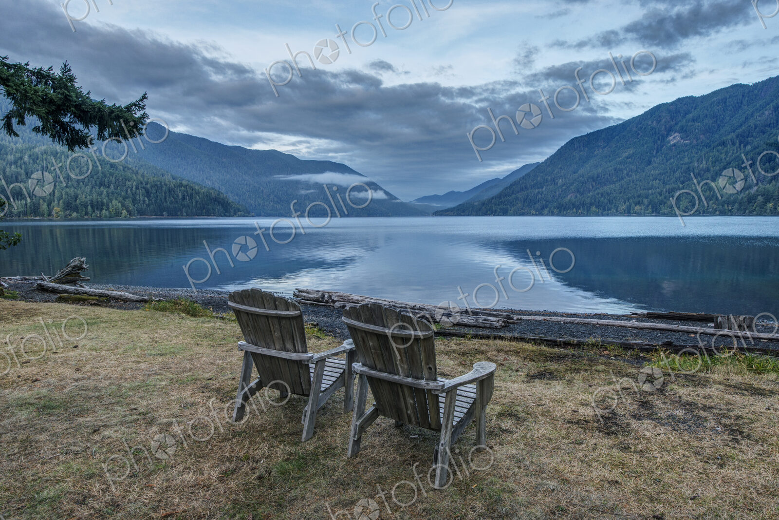 Two Adirondack style wooden lounge chairs at Crescent Lake Lodge at Olympic National Park.