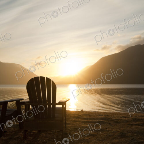 Two Adirondack style wooden lounge chairs at Crescent Lake Lodge at Olympic National… Two Adirondack style wooden lounge chairs at Crescent Lake Lodge at Olympic National…