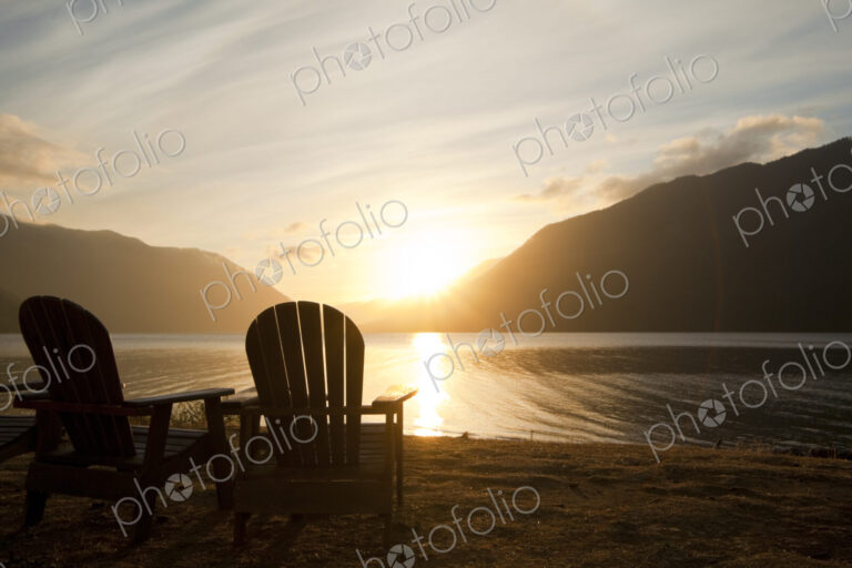 Two Adirondack style wooden lounge chairs at Crescent Lake Lodge at Olympic National…