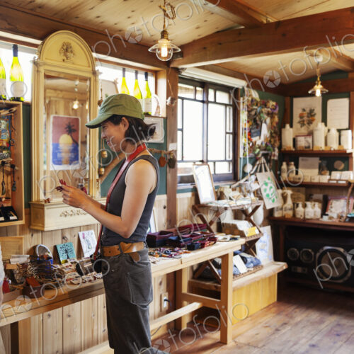 Two Japanese women and man standing in a leather shop.