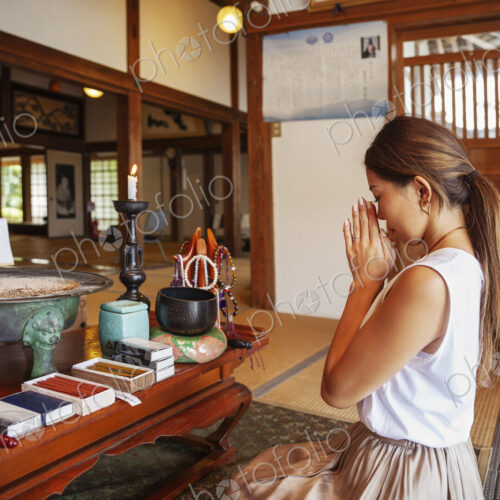 Two Japanese women kneeling in Buddhist temple, praying. Two Japanese women kneeling in Buddhist temple, praying.