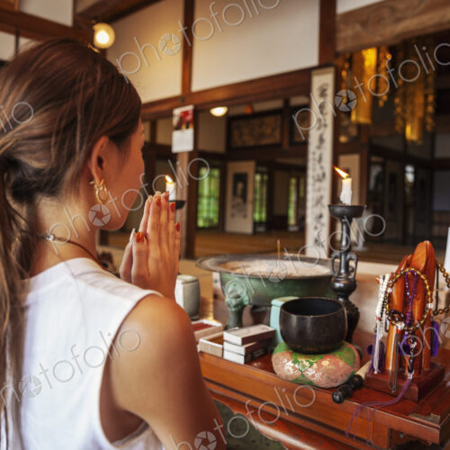 Two Japanese women kneeling in Buddhist temple, praying. Two Japanese women kneeling in Buddhist temple, praying.