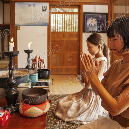 Two Japanese women kneeling in Buddhist temple, praying. Two Japanese women kneeling in Buddhist temple, praying.