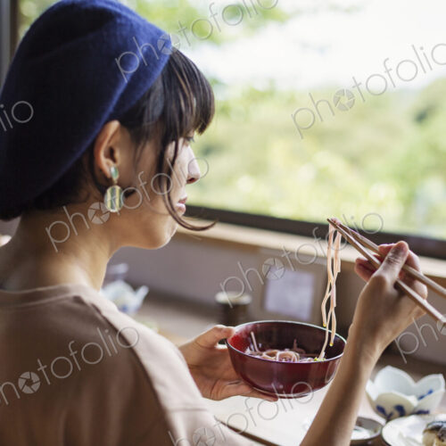 Two Japanese women sitting at a table in a Japanese restaurant, eating. Two Japanese women sitting at a table in a Japanese restaurant, eating.