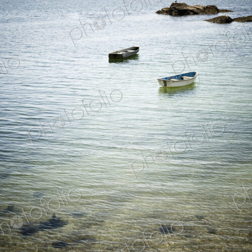 Two Rowboats Near a Beach Shore Two Rowboats Near a Beach Shore