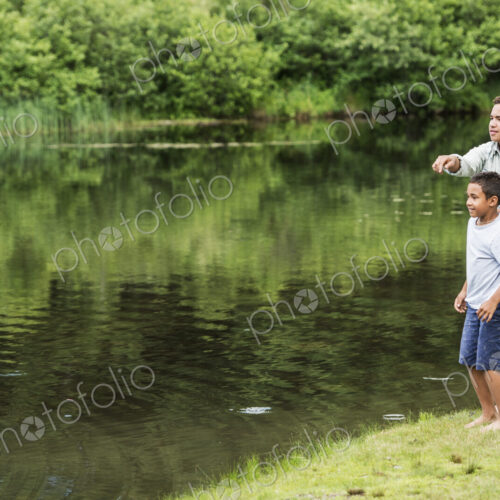 Two brothers playing by a lake. Two brothers playing by a lake.