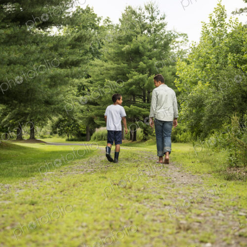 Two brothers walking on a country path.