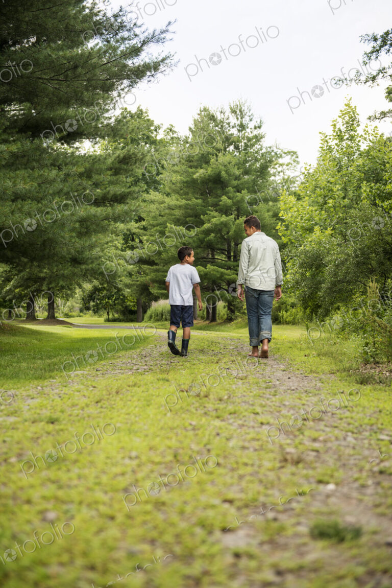 Two brothers walking on a country path.