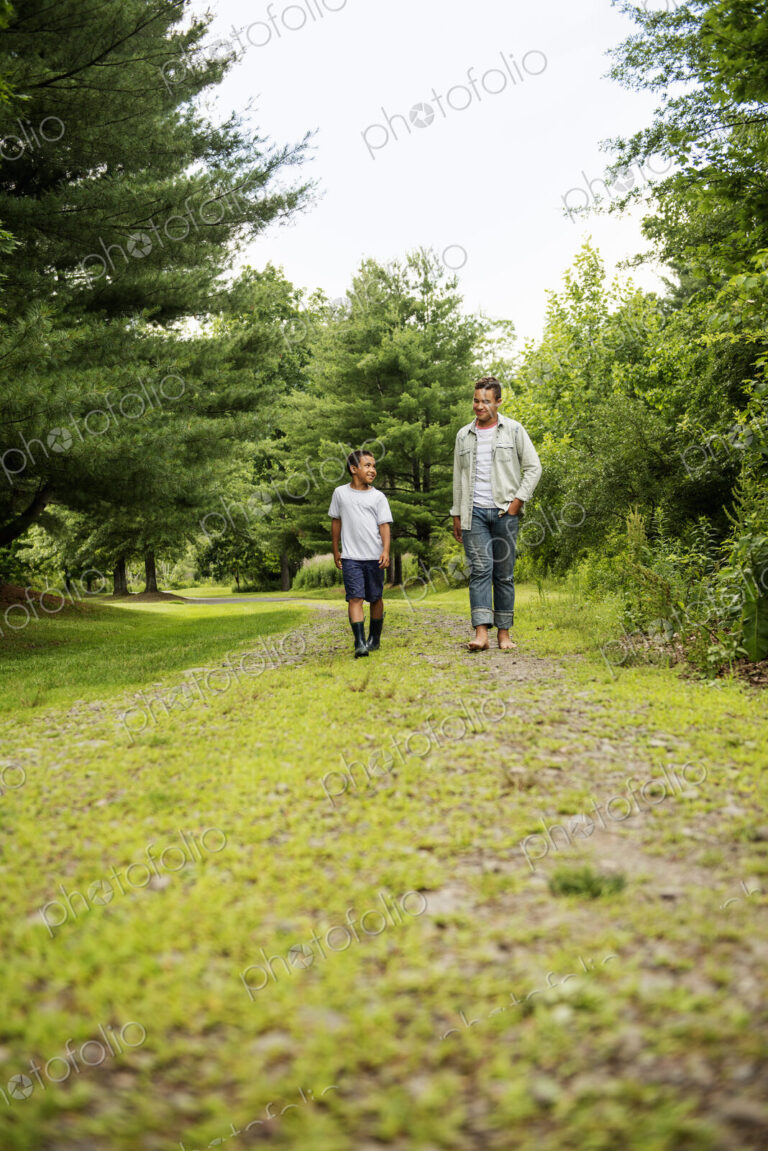 Two brothers walking on a country path.