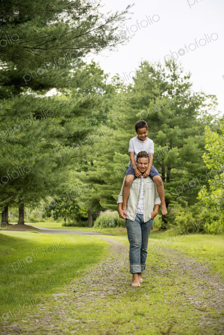 Two brothers walking on a country path.