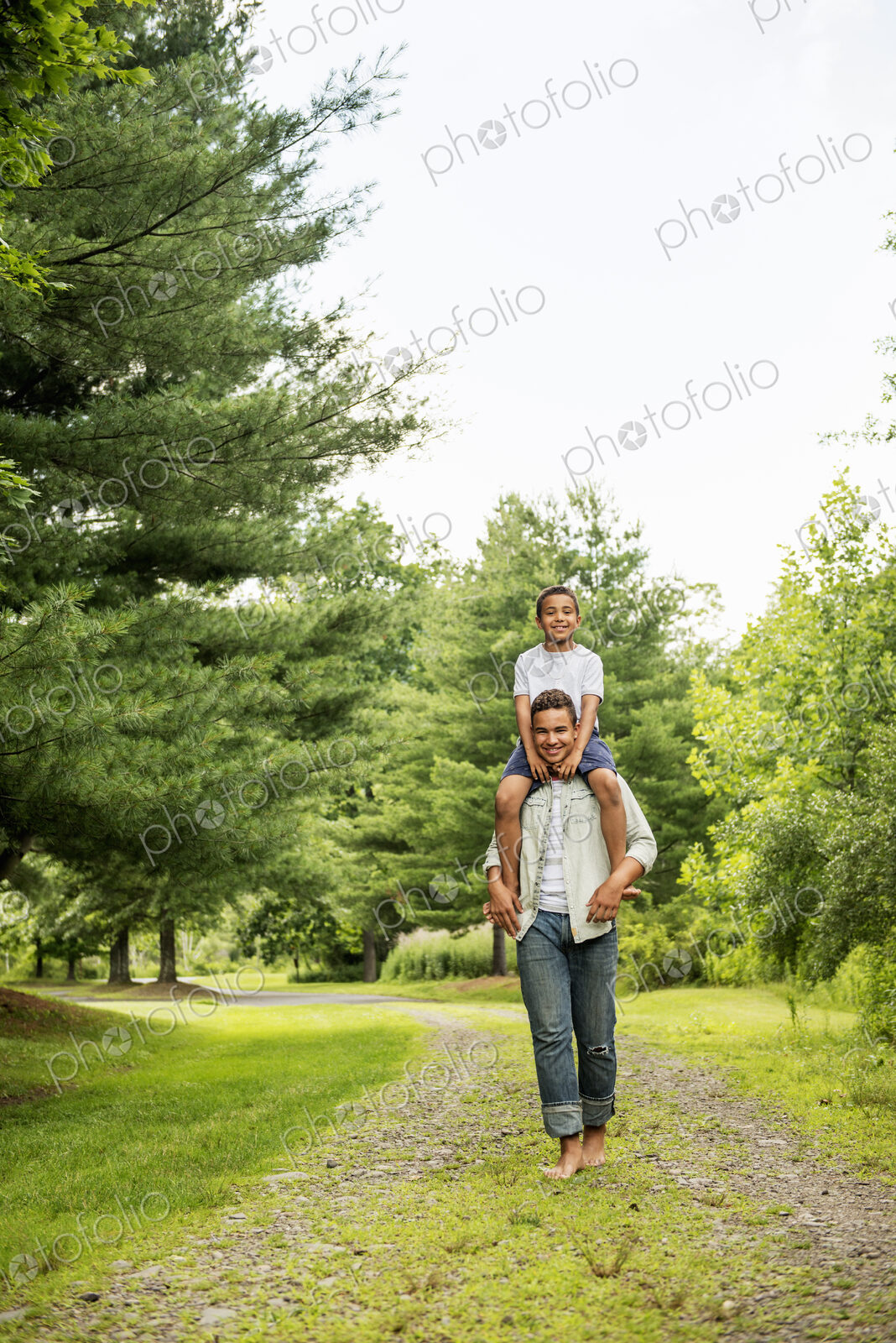 Two brothers walking on a country path.
