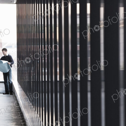 Two business owners standing in their new empty raw business space.