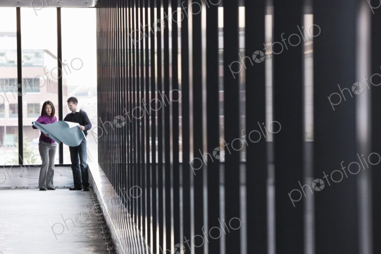Two business owners standing in their new empty raw business space.