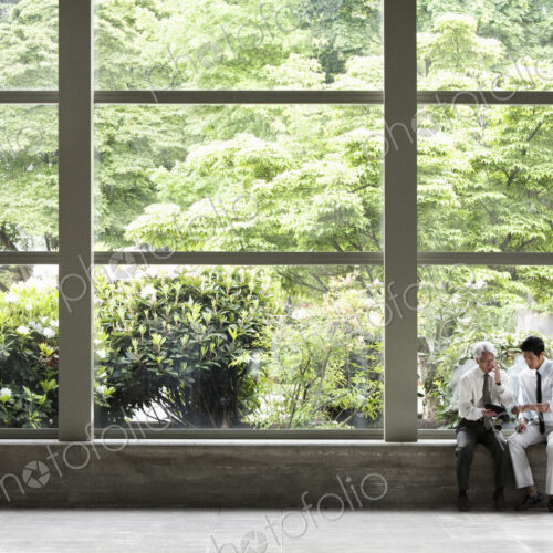 Two businessmen working on a notebook computer Two businessmen working on a notebook computer