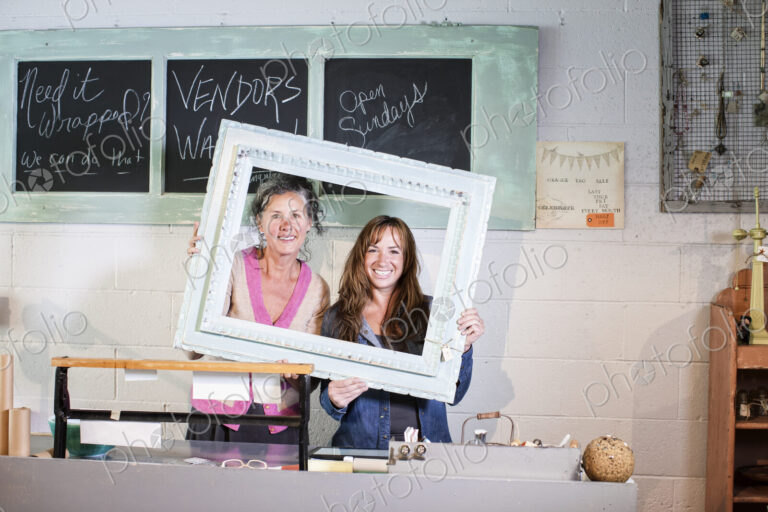 Two caucasian women onwers of an antique store.