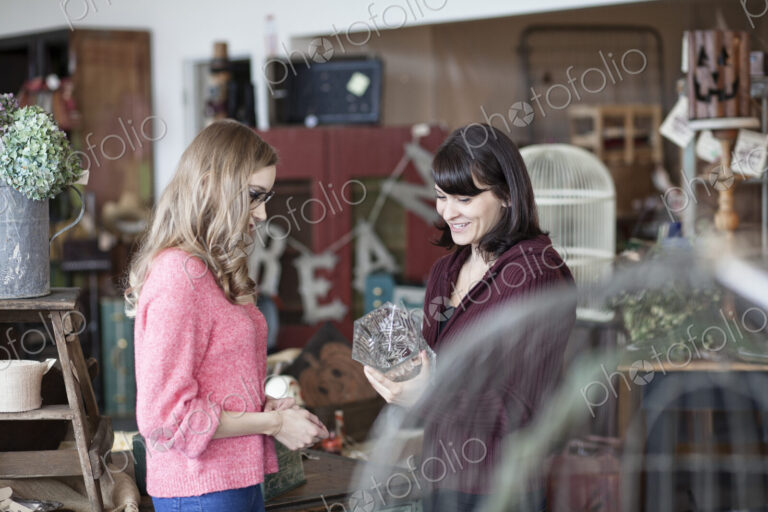 Two caucasian women shopping in an antique store