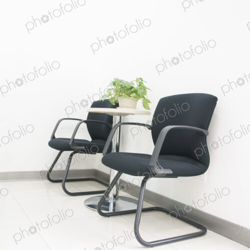 Two chairs and a table in an office