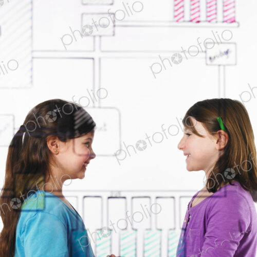 Two children facing each other behind a drawing of a computer motherboard circuit… Two children facing each other behind a drawing of a computer motherboard circuit…
