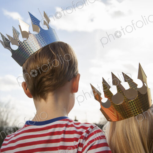 Two children in fancy dress, wearing crowns. Two children in fancy dress, wearing crowns.