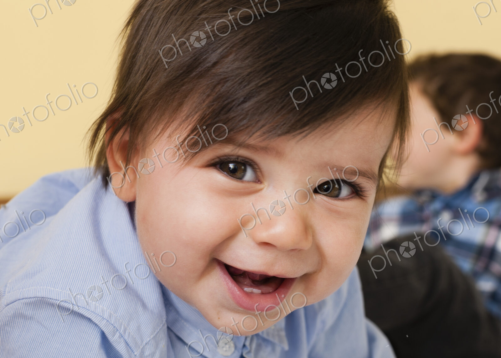 Two children playing on a bed.