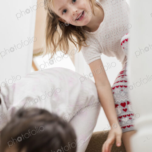 Two children playing on the stairs.