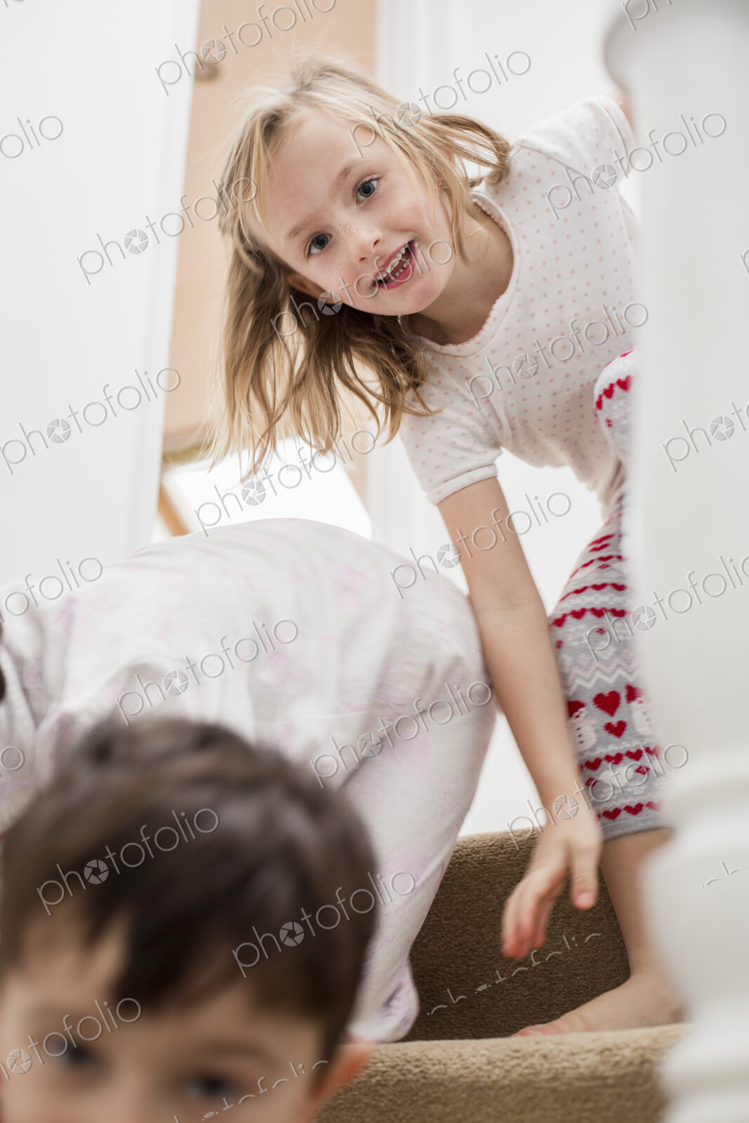 Two children playing on the stairs.