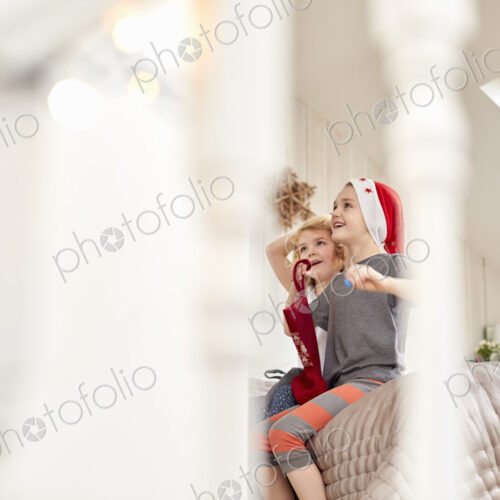 Two children waking up on Christmas morning. Two children waking up on Christmas morning.