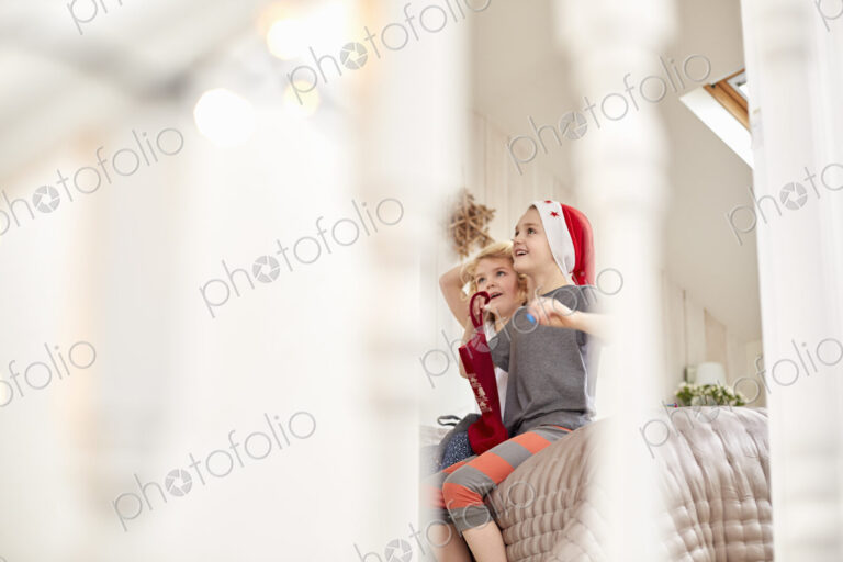 Two children waking up on Christmas morning.