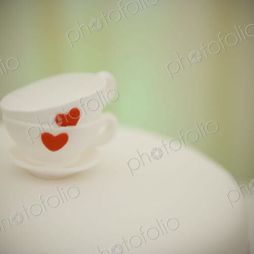 Two china cups stacked one on the other, and decorated with a red heart. Two china cups stacked one on the other, and decorated with a red heart.
