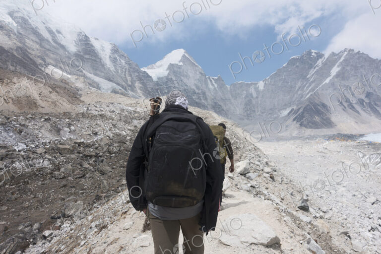 Two climbers hiking along a path in the mountains