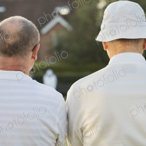 Two companions, two men standing side by side in white shirts outdoors. Lawn bowls… Two companions, two men standing side by side in white shirts outdoors. Lawn bowls…