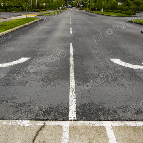 Two directional Arrow symbols curving left and right away from each other on a road… Two directional Arrow symbols curving left and right away from each other on a road…