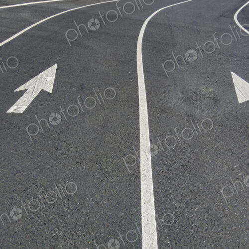 Two directional Arrow symbols on the road surface, on a city road in Seattle. Two directional Arrow symbols on the road surface, on a city road in Seattle.
