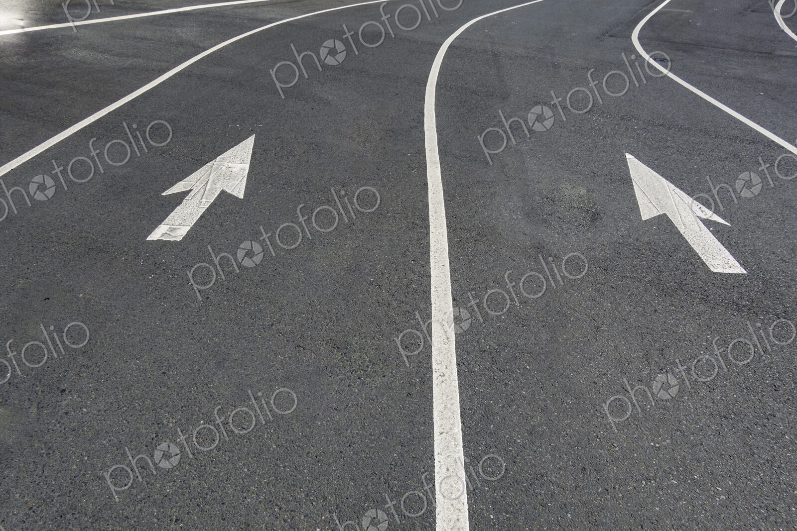 Two directional Arrow symbols on the road surface, on a city road in Seattle.
