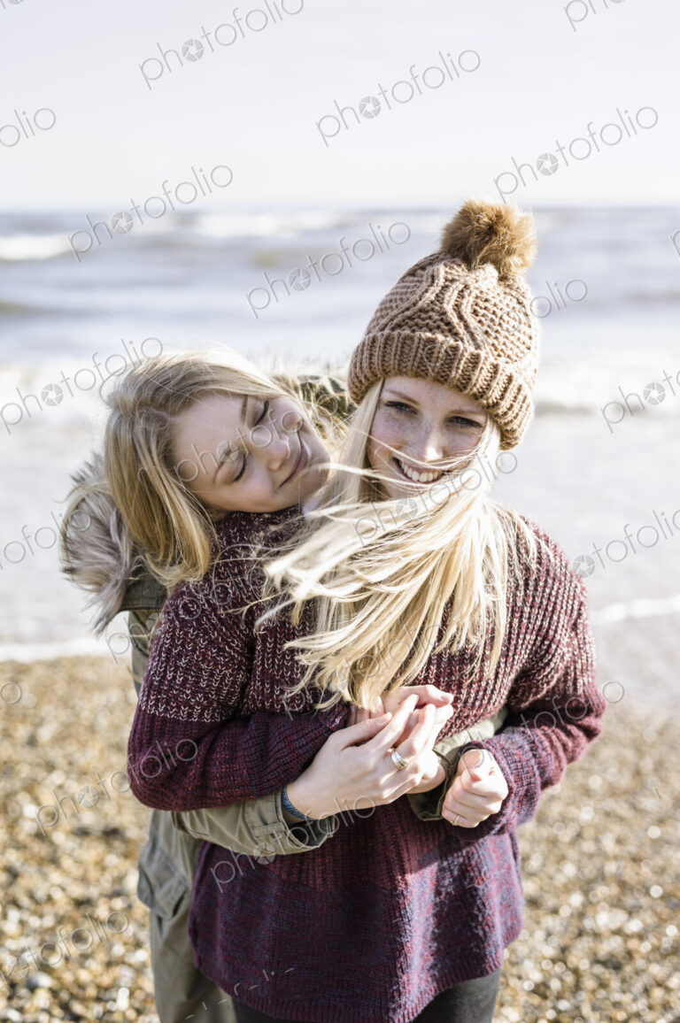 Two girls on the beach in winter.