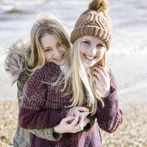 Two girls on the beach in winter.