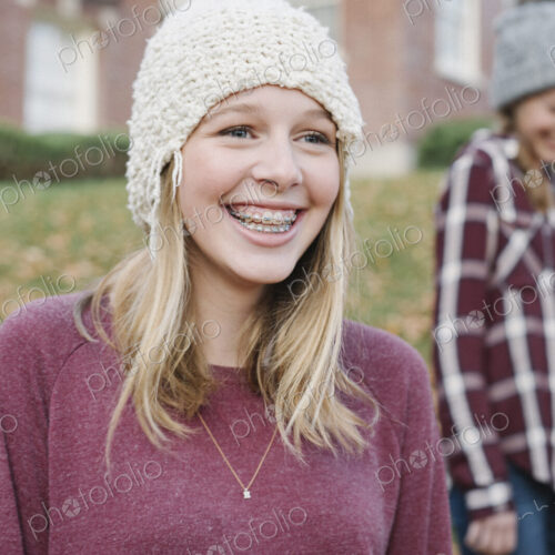 Two girls outdoors in woolly hats in autumn. Two girls outdoors in woolly hats in autumn.
