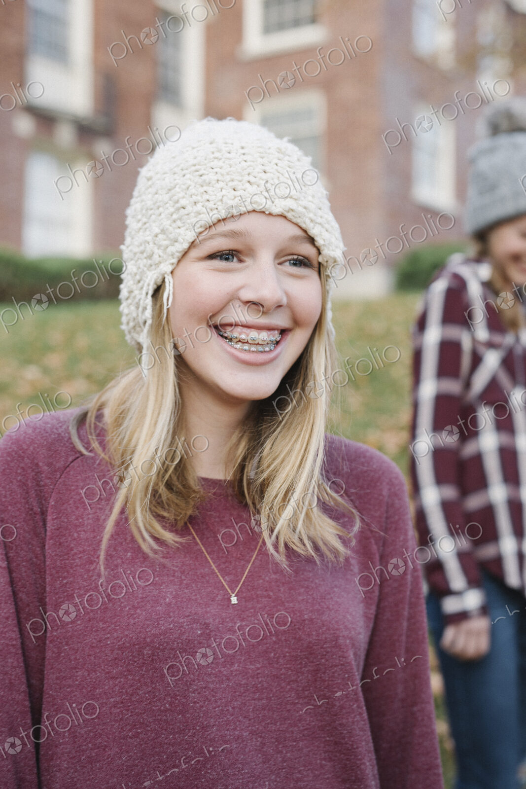 Two girls outdoors in woolly hats in autumn.