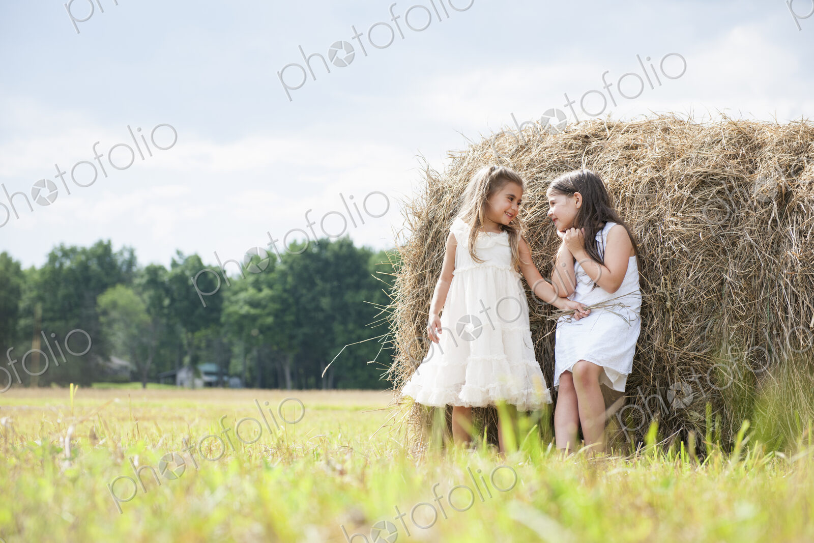Two girls playing outdoors.