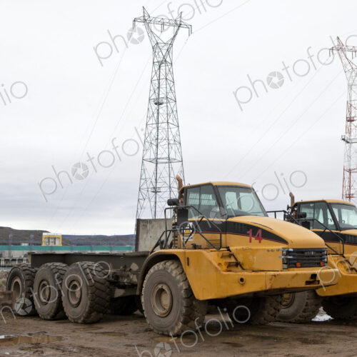 Two large trucks on a construction site, Two large trucks on a construction site,