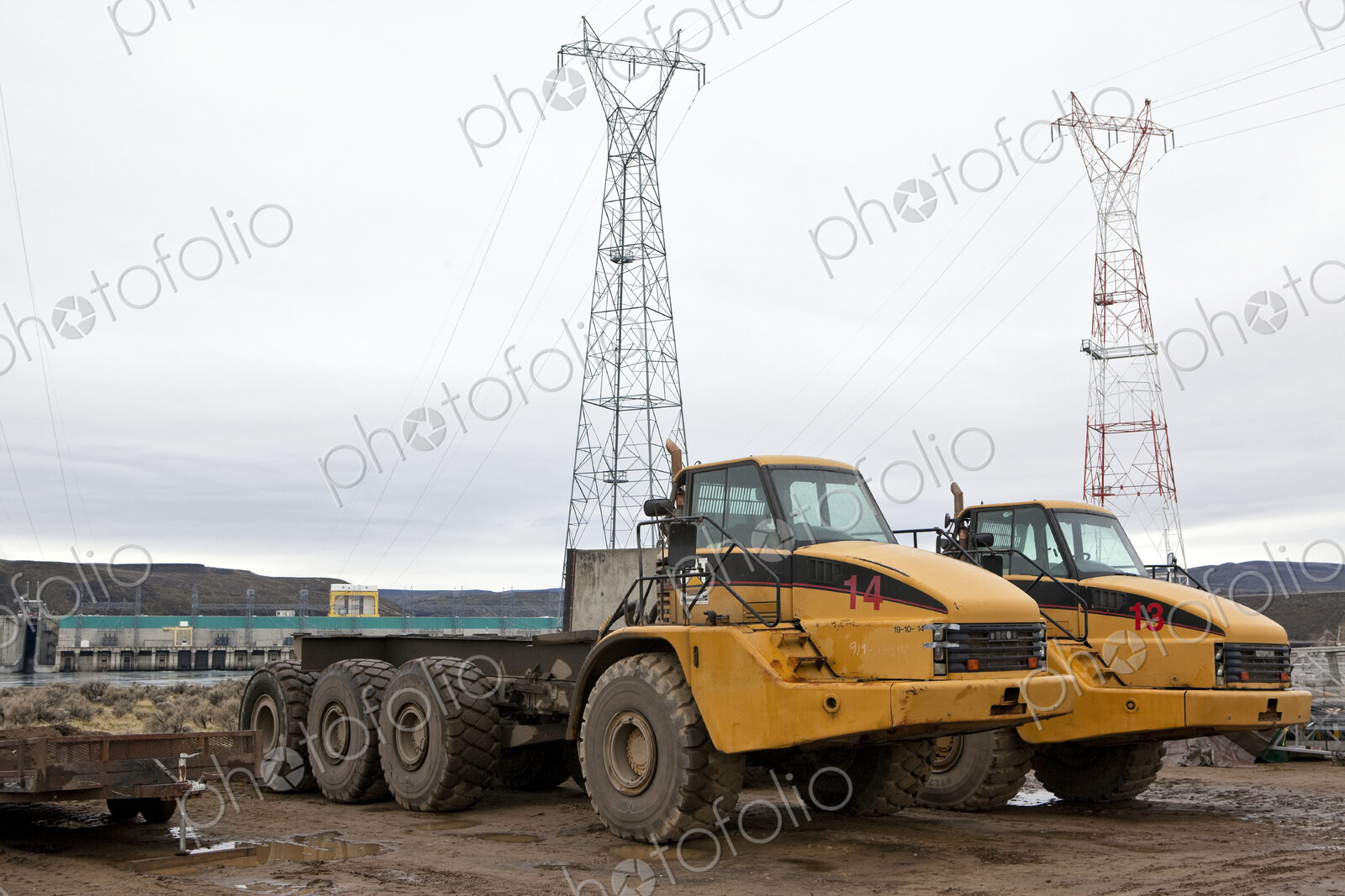 Two large trucks on a construction site,