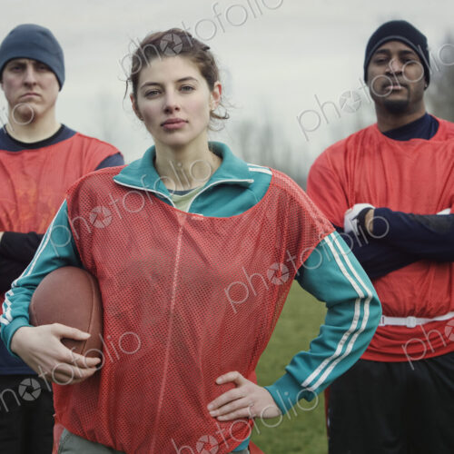 Two men and a woman, members of a team of American flag football players. Two men and a woman, members of a team of American flag football players.