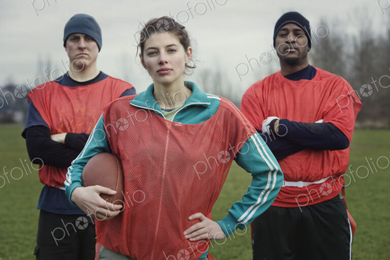 Two men and a woman, members of a team of American flag football players.